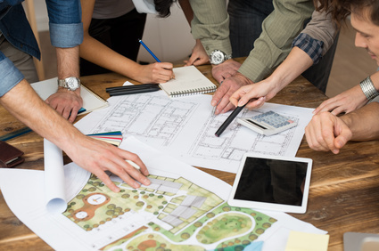 Architect team discussing on blueprints